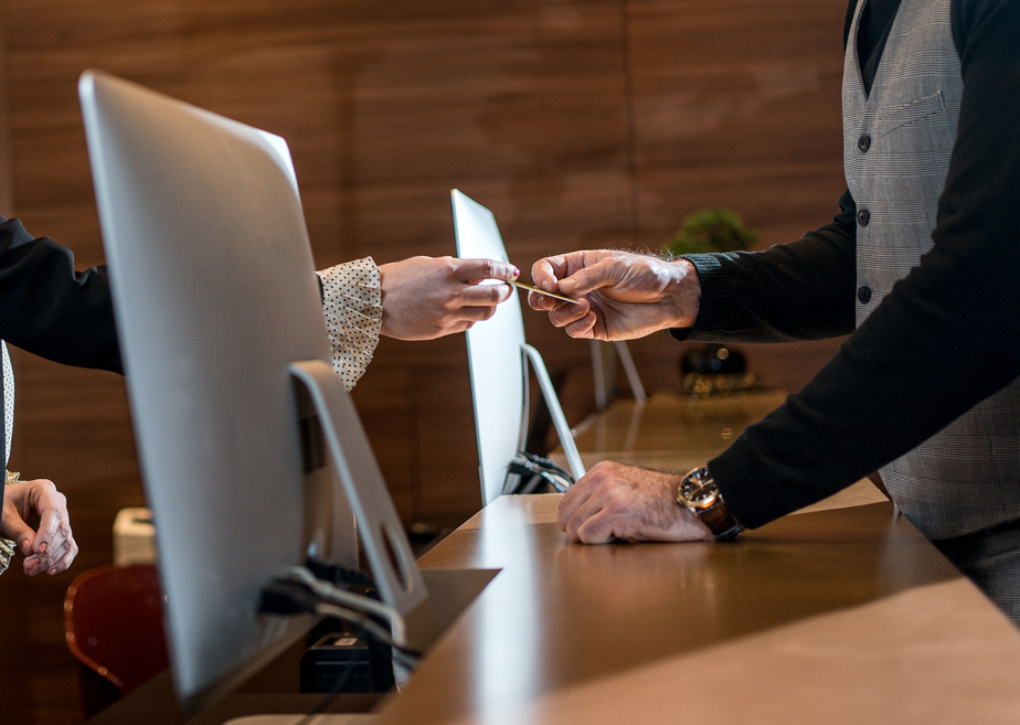 Businessman Paying at Hotel Reception