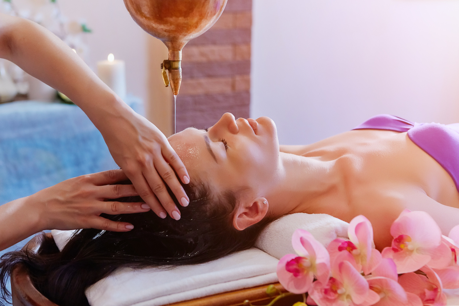 Caucasian woman having Ayurveda shirodhara treatment